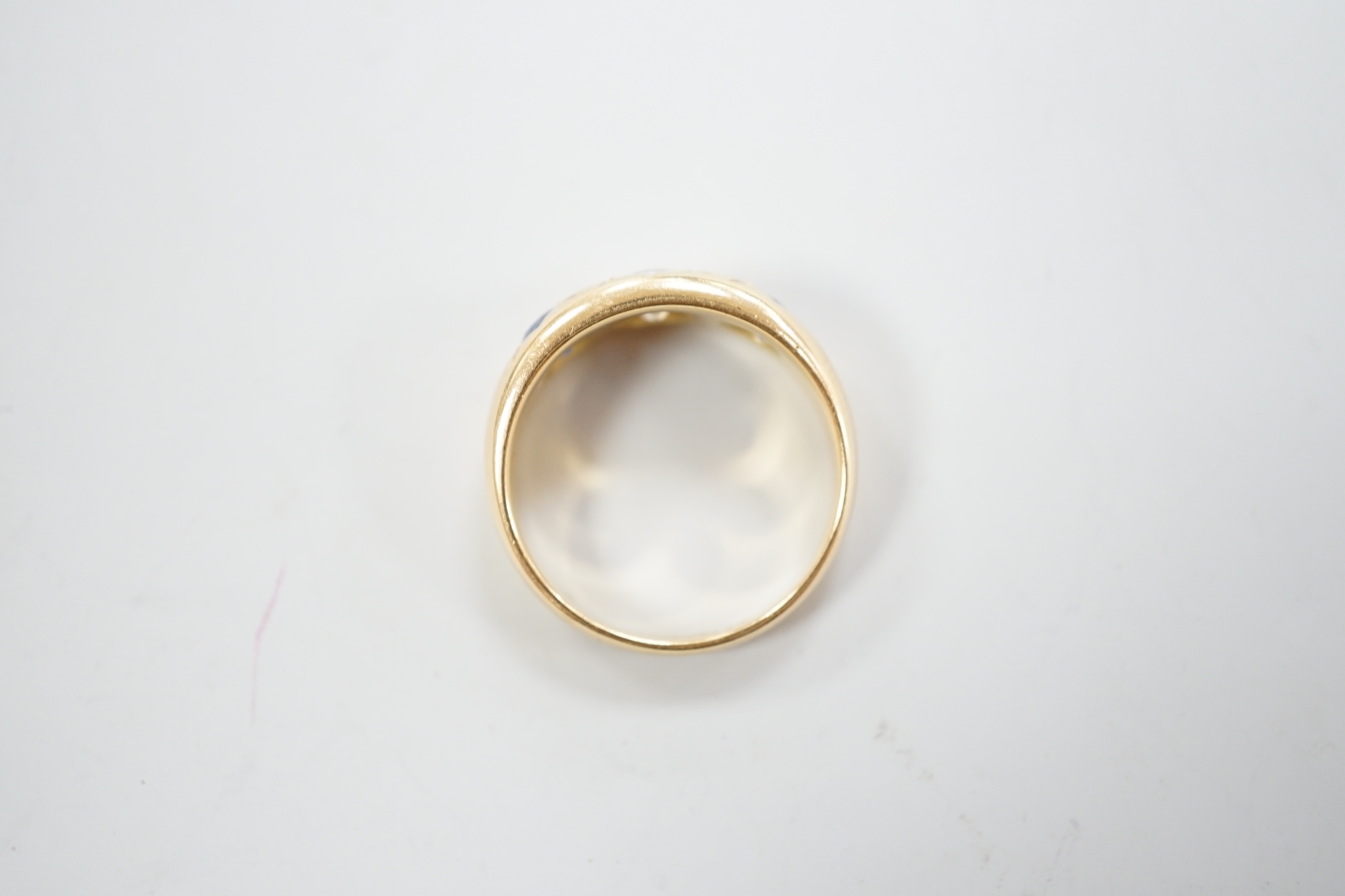 An early 20th century 18ct gold and gypsy set single stone diamond and two stone sapphire set ring, size O, gross weight 6.4 grams.